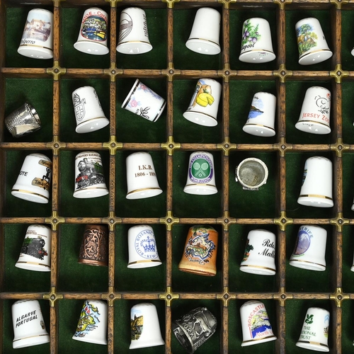 534 - A collection of 148 thimbles, including silver examples, displayed in a printer's typesetting drawer... 