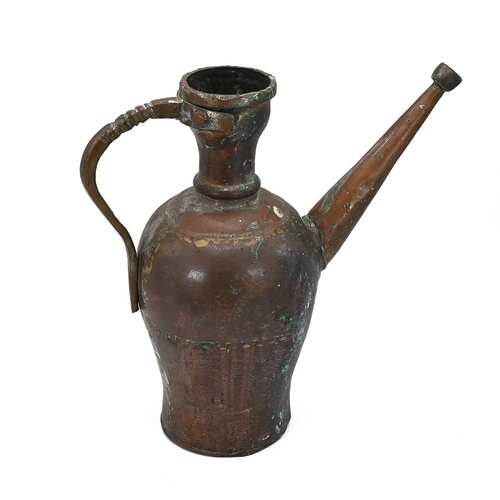 569 - A Middle Easter hammered copper water jug with pronounced brass handle and long angled spout. H 34.5... 