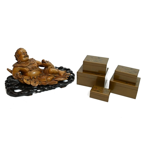 571 - A carved Chinese teak model of a buddha with a reptile, along with set of lacquered boxes 