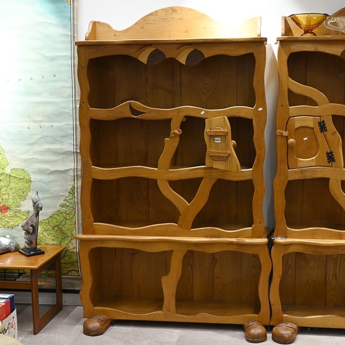 579 - A late 20th Century character oak bookcase, with carved eyes and booted feet. H 197cm, W 112cm, D 38... 