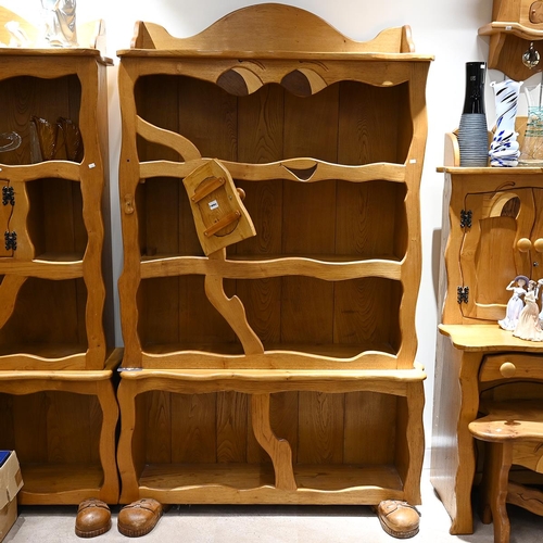 580 - A late 20th Century character oak bookcase, with carved eyes and booted feet. H 197cm, W 112cm, D 38... 