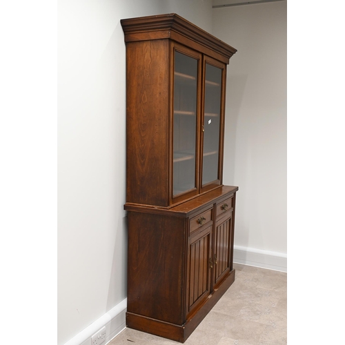 585 - Edwardian glazed oak bookcase, the upper part a stepped pediment over  two glazed doors, with brass ... 