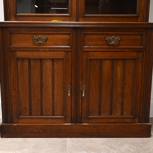 585 - Edwardian glazed oak bookcase, the upper part a stepped pediment over  two glazed doors, with brass ... 