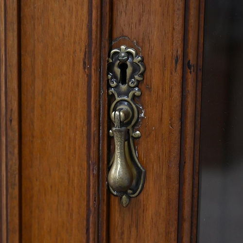 585 - Edwardian glazed oak bookcase, the upper part a stepped pediment over  two glazed doors, with brass ... 