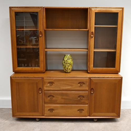 586 - Mid Century Ercol light elm bookcase, comprising central shelved bookcase flanked by glazed and shel... 