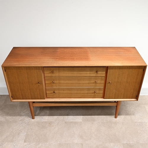 588 - A Mid-Century Gordon Russell teak sideboard with three long drawers, one with felt lined cutlery tra... 