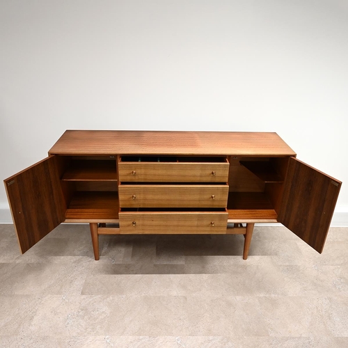 588 - A Mid-Century Gordon Russell teak sideboard with three long drawers, one with felt lined cutlery tra... 