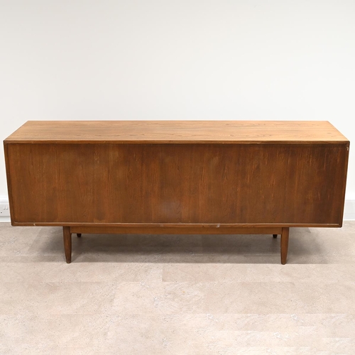 591 - An Ensign Elm sideboard by Bristow and Townsend comprising four long drawers flanked by cupboards wi... 