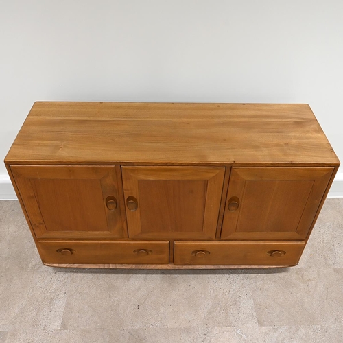 592 - Ercol Windsor light elm sideboard, fitted with three cupboards over two drawers all with carved oval... 