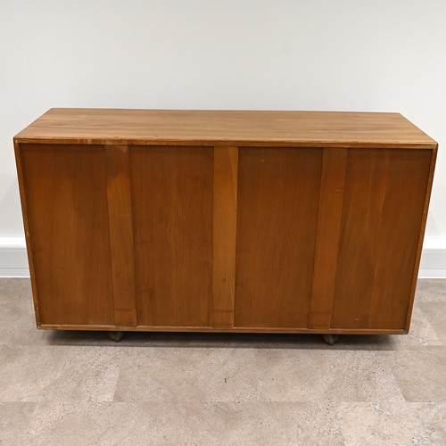 592 - Ercol Windsor light elm sideboard, fitted with three cupboards over two drawers all with carved oval... 