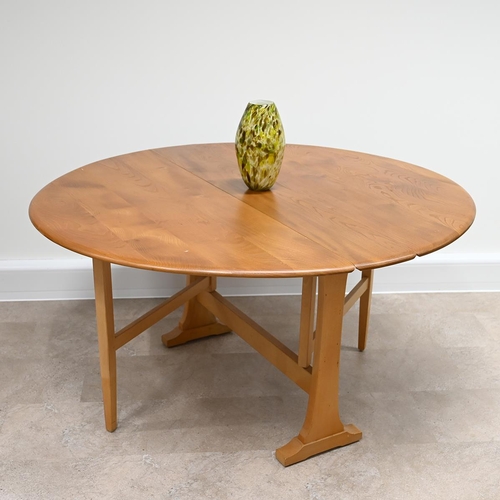 600 - A Mid-Century Ercol Blonde elm and beech Model 610 drop leaf Sutherland oval dining table. Part of t... 