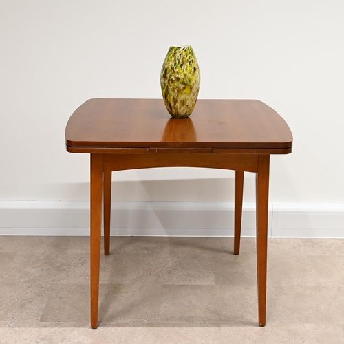 602 - Mid Century Teak dining table and four chairs. The draw-leaf extending table of rounded square form ... 