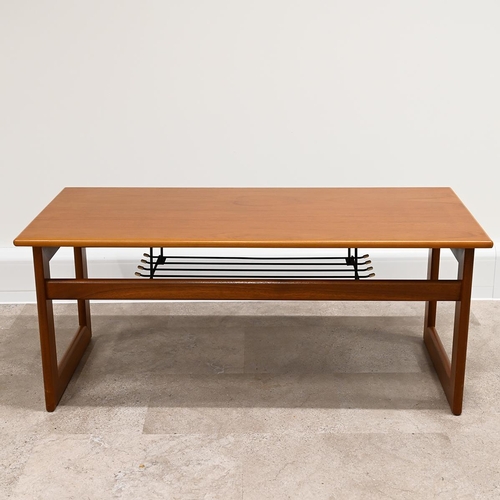 606 - Mid Century teak coffee table of rectangular form with wire magazine tray under raised on square fra... 