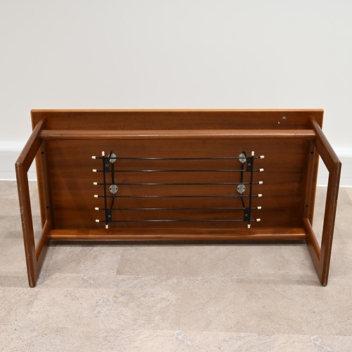 606 - Mid Century teak coffee table of rectangular form with wire magazine tray under raised on square fra... 