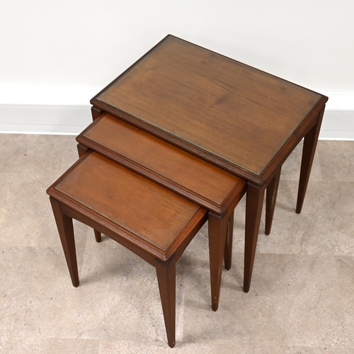 607 - Mid century teak nest of three tables of rectangular form, each with inset glass protectors, raised ... 