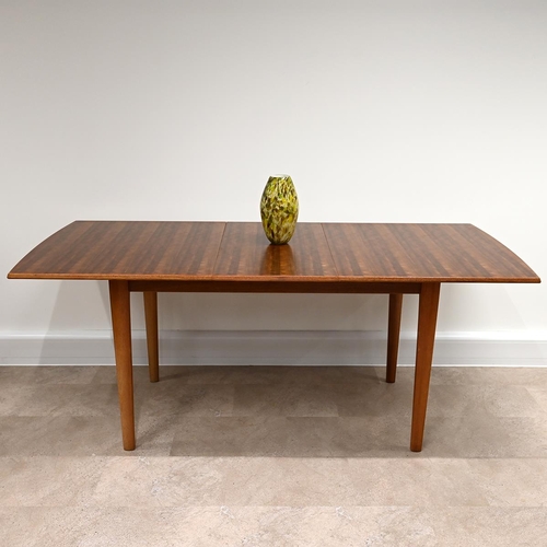 612 - A Mid-Century Gordon Russell for Heals teak extending dining table and 6 chairs (one of which is a c... 