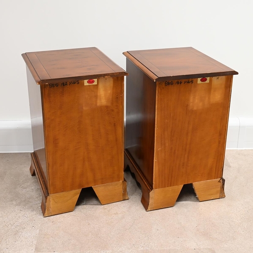 622 - A pair of Bradley yew wood bedside cabinets each with three drawers, with brass swan neck handles, a... 