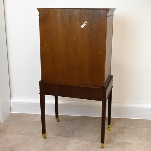 623 - Mid 20th Century mahogany cocktail cabinet with two panelled doors, opening to reveal a mirror-backe... 