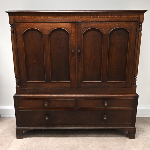 630 - 19th Century Oak Linen Press Cupboard comprising two doors, flanked by turned and facetted columns, ... 