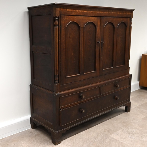 630 - 19th Century Oak Linen Press Cupboard comprising two doors, flanked by turned and facetted columns, ... 