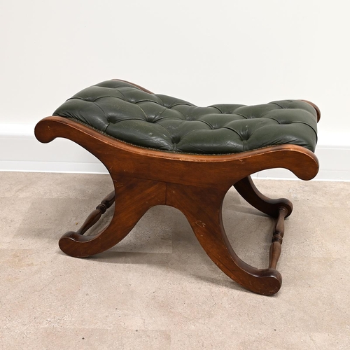 633 - A Saddle style footstool, in the manner of Chesterfield, with buttoned green leather top and mahogan... 