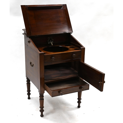 637 - A Victorian mahogany washstand with sloping top opening to reveal recesses for wash bowl and a brass... 