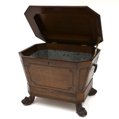 639 - A Regency (circa 1820) mahogany wine cooler. Of sarcophagus shape with brass laurel wreath ring hand... 