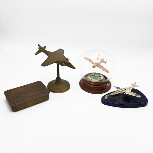 180 - A WWI Queen Mary Christmas tin, along with a brass model of a plane and two other model planes 