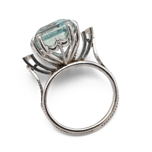 1 - A 15ct white gold aquamarine and diamond cocktail ring, the step cut aquamarine approximately 17mm x... 