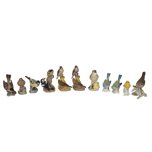 102 - Royal Worcester - six porcelain bird figurines to include: Nightingale (a/f); Pied Woodpeckers; Amer... 