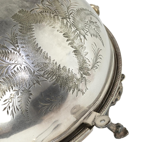 13 - A silver plated meat warmer/server, the front section engraved with ferns and standing on outstretch... 