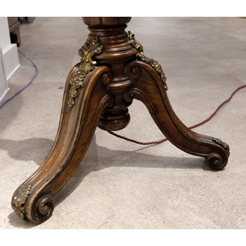 38 - An Edwardian walnut standard lamp, with turned column to carved downswept and scroll footed tripod b... 