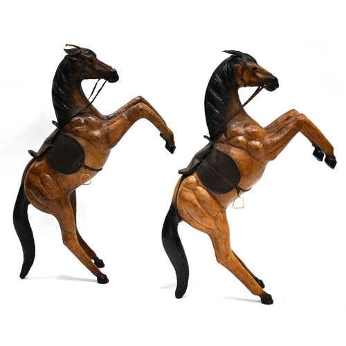 44 - Two decorative leather covered rearing horses in the manner of Liberty. Dimensions each: 85cm high x... 