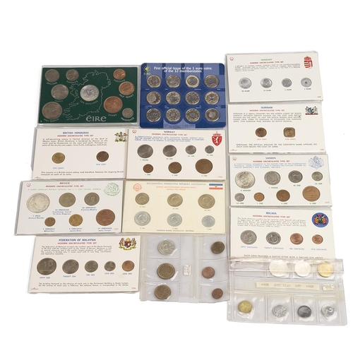 391 - Thirteen (13) world coin sets, the coins primarily dating from the 1960s, largely uncirculated. Incl... 