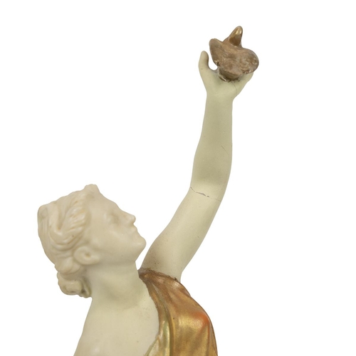 128 - Royal Worcester early 20th Century figurine of Liberty, holding a dove aloft (H 25.5cm) with puce ma... 