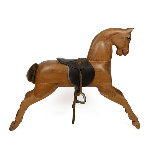 130 - Mid 20th Century carved pine rocking horse, lacking rocking base, with leather saddle and stirrups, ... 