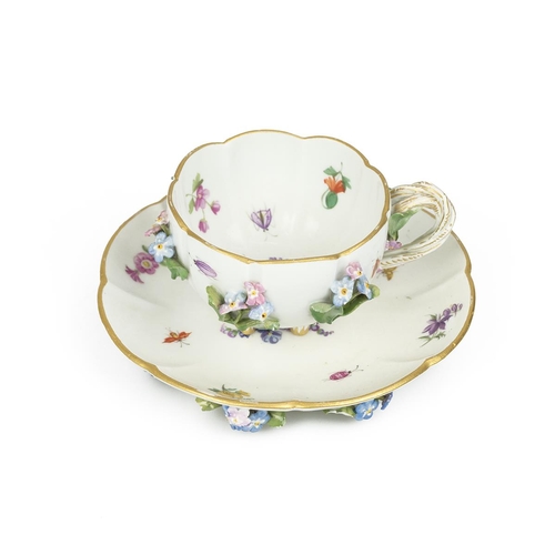 149 - A 19th Century Flowers and Bugs tea cup and saucer encrusted with flowers, bearing the Meissen cross... 