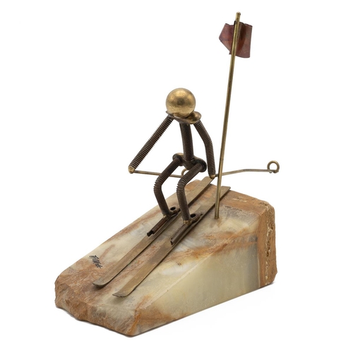 194 - John DeMott - The Skier 1970's sculpture in brass on a honey quartz base depicting a slalom skier. H... 