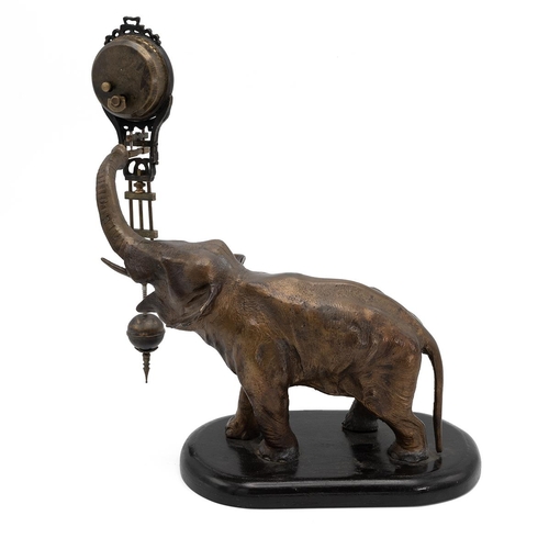 199 - Mystery Clock by Junghans, in the form of a cast metal elephant, its raised trunk supporting the clo... 