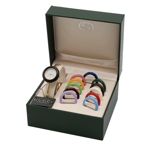 25 - Gucci change bezel gold plated wrist watch with white dial, model 1100L in green leather box, with 1... 