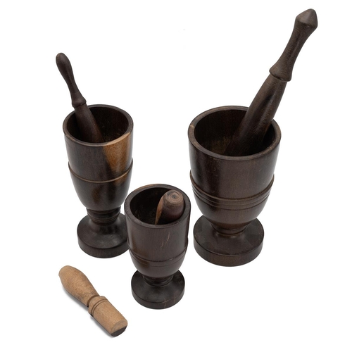 326 - Three turned wooden goblet shaped  mortars with four various turned wooden pestles. (7).