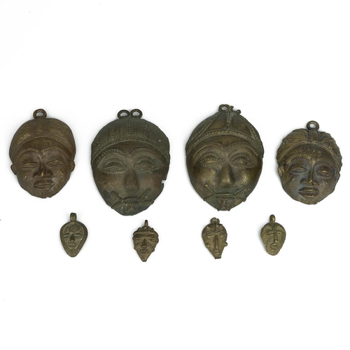 331 - West African miniature Baule masks - eight in total - ranging in size from 4.5cm to 13cm. (8)