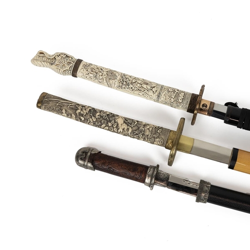 338 - Collection of four reproduction collector samurai swords, the grip decorated with various figures an... 