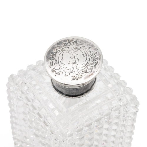 34 - Cut glass cologne flask with silver screw top of square form with diamond cut pattern. H 9.5cm.