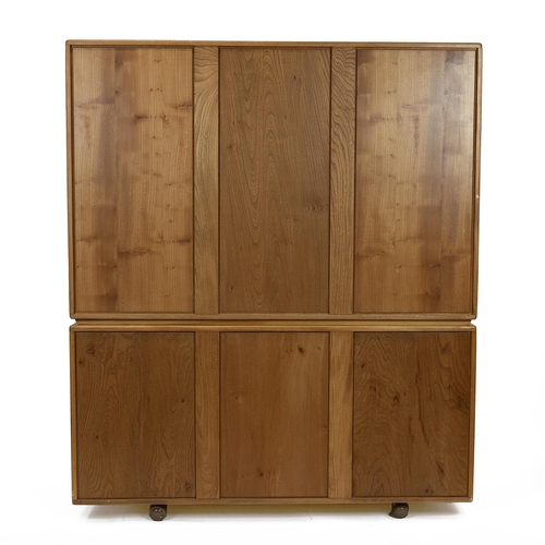 396 - Ercol light elm Windsor design bookcase sideboard. Three glazed doors opening to reveal adjustable s... 