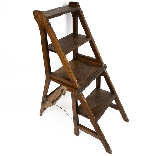 415 - A late 19th/early 20th century light oak Gothic metamorphic library steps chair, the panelled back w... 