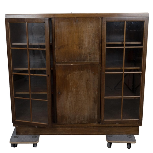 425 - 1930's oak cabinet comprising central drop down door opening to reveal a cocktail cabinet over a cup... 