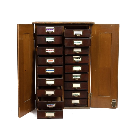 427 - Early 20th Century pine haberdasher's cabinet with lockable panel doors opening to reveal 18 drawers... 