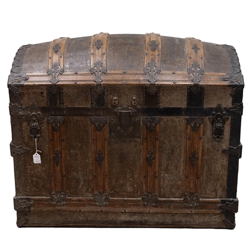 428 - 19th Century iron bound oak domed top trunk the leathered panelled lid opening to reveal a paper lin... 