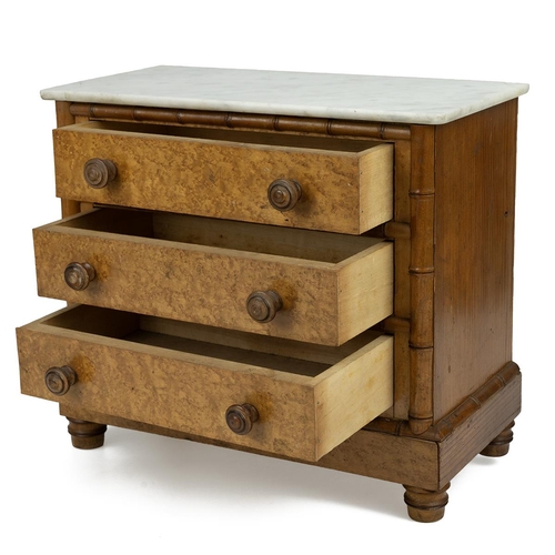 436 - An early 20th-century burr maple veneer apprentice chest of drawers, with a white marble top, faux b... 